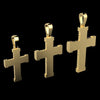 Three gold cross pendants of different sizes displayed against a solid black background.