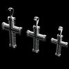Three silver cross pendants with textured, ribbed details and looped bail tops, displayed against a solid black background.