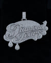 A large silver-tone 'Diamond Tears' pendant covered in sparkling clear stones, displayed against a solid black background.